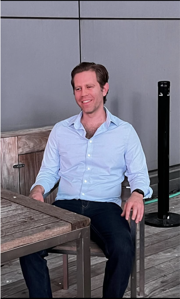 Jesse seated in a blue shirt with sample landmark points over the crown, chin, shoulders, and hips